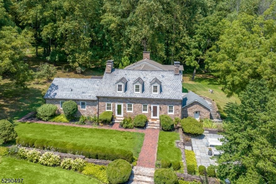 Nestled in the serene countryside of Sergeantsville, NJ, this circa 1737 home boasts four bedrooms and three and one half baths. The timeless charm of the stone exterior and slate roof is complemented by modern updates.  Recent additions include a bright, modern kitchen with high-end appliances and an oversized island, plus a spacious mudroom and laundry room with custom built-ins.  As you enter the home you are greeted with an oversized stone surround fireplace, one of the three wood burning fireplaces.  The sunroom, family room and screened in porch which is attached to the primary bedroom all overlook extensive slate patios surrounded with fieldstone walls and a large pond with dock at a short distance.  A first floor bedroom suite includes full bathroom with a large stall shower.  The property also features a separate guest cottage with two bedrooms and two full baths, a full kitchen complete with island and one car garage.  A detached three-car garage with a game room sits across a circular driveway away from main house.  Extending down a short driveway, there is a new climate controlled barn currently used for car storage. Beyond the barn are extensive open fields.  Spanning over 200 plus acres, this estate offers ample privacy and a picturesque setting, ideal for those seeking a blend of historic charm and modern amenities, hobby farm, multi-generational compound and/or the potential for subdivision. Home is circa 1737 but owners maintain development rights.