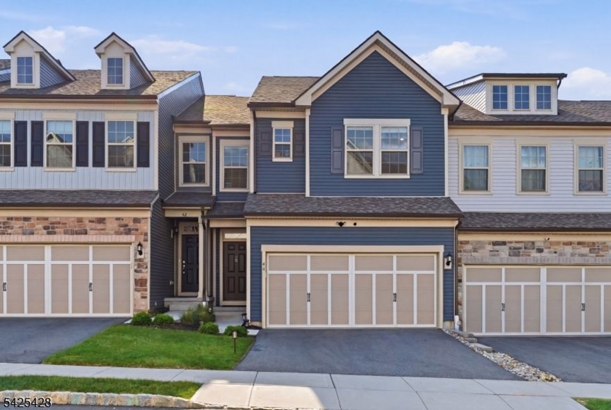 Welcome to this impeccably upgraded 3 years young Ashton model in Fairview at Warren, where over $150,000 in enhancements set this home apart. Designed for everyday living and effortless entertaining, the open-concept layout centers around a chef's kitchen featuring premium cabinetry, quartz countertops, and a high-end KitchenAid appliance package. The space flows seamlessly into sunlit living and dining areas overlooking private wooded surroundings for a rare sense of tranquility. Upstairs, you'll find three spacious bedrooms, including a luxurious primary suite with a spa-like bath and frameless glass shower, along with an upper-level laundry room. Every bathroom throughout the home has been tastefully upgraded with elevated finishes. The fully finished lower level offers exceptional flexibility, complete with a full bath, large daylight windows and a bonus room ideal for a guest suite, home office, or gym, creating an expansive extension of the home's living space. Additional highlights include a 2-car attached garage with private driveway parking, HVAC zoning, upgraded flooring throughout, and an EV charger. Ideally located just moments from Route 78 with a convenient commute to New York City, and close to Warren's highly regarded schools, parks, and vibrant downtown filled with upscale dining and everyday conveniences, this home offers the perfect balance of privacy, luxury, and accessibility. Optional furnished sale available.