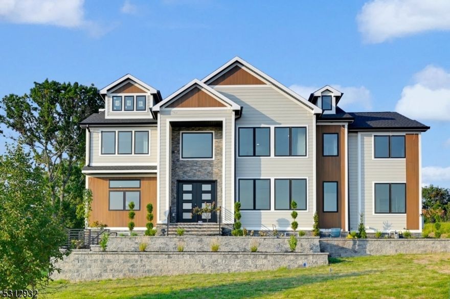 Welcome to this stunning 6 BED, 5.5 BA new construction custom colonial home w 3 car garage & 6,500+ sft of beautifully finished living space spread across 3 floors. Nestled on a spacious 3/4-acre plot in the sought-after Pinebrook section of Montville, this home is designed for luxurious living. As you enter, you're greeted by an inviting open floor plan & a grand ent. lobby, flanked by a formal dining room on one side & a formal living room on the other. The beautiful HW floors & custom millwork throughout add an elegant touch to every room. The expansive kitchen & family room are the heart of the home, complete with an electric FP with tile surround and sliders that open to a deck overlooking the lush backyard. The kitchen is a chef's dream, featuring custom ceiling-height cabinetry, high-end SS appliances, a large center island with quartz countertops, a walk-in pantry & a convenient first-floor en-suite bedroom. Upstairs, you'll find 4 generously sized bedrooms, incl. a gracious primary suite W custom walk-in closets & a spa-like bath W soaking tub, stall shower & dual sinks. One additional bedroom features an en-suite bathroom, while the other two bedrooms share a full bath. The 2nd floor also includes a laundry rm for added convenience. The fin. basement W 9-foot ceilings offers even more living space, incl. a bedroom, full bath & a large recreation room with a built-in bar, Includes smart home features like Nest, Ring, and EV charger outlets.10-YEAR BUILDER'S WARRANTY