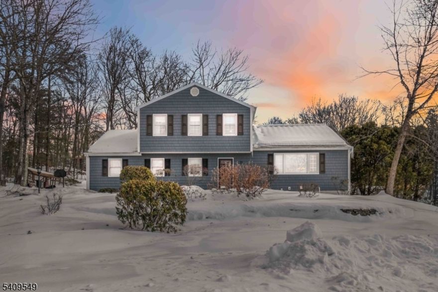 Tucked away on a quiet cul-de-sac in the highly desirable Old Milford Estates section of West Milford, this beautifully maintained home offers warmth, space, and comfort in an exceptional setting. From the moment you arrive, it is clear that this property has been lovingly cared for and reflects true pride of ownership throughout.Inside, you will find three spacious bedrooms and light-filled living areas that feel open, bright, and inviting. The kitchen is airy and cheerful, flowing easily into the main living spaces and making everyday living and entertaining effortless. The first floor features both a formal living room and a comfortable family room, offering flexibility for gatherings or quiet relaxation.A charming three-season porch or sunroom overlooks the level backyard, creating a perfect spot to unwind and enjoy the outdoors in comfort. The finished basement adds valuable extra living space, ideal for a recreation area, home office, or hobby room.Completing the home is an oversized two-car garage and the convenience of public utilities. The location is hard to beat, just minutes from the center of town, shopping, schools, and houses of worship. In excellent condition and move-in ready, this home is a rare opportunity to enjoy quality, space, and an outstanding neighborhood all in one welcoming package.