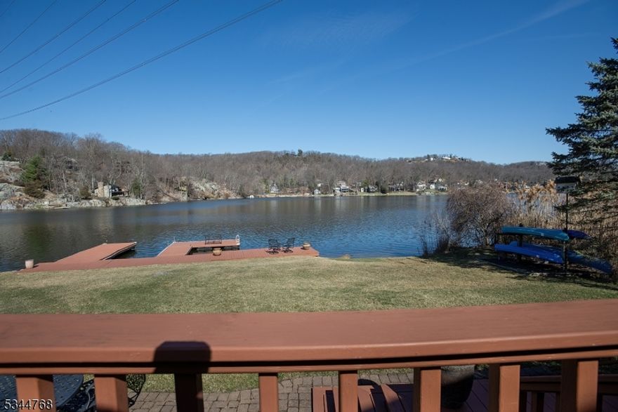 Welcome to this charming 3-bedroom, 2-full-bath lakefront home in the highly sought-after Lake Mohawk. As you enter, you'll be greeted by an open living room, dining room, and kitchen with a stunning wall of custom sliding glass doors that offer breathtaking views of the lake. Step out onto the expansive deck, complete with a hot tub and ample space for entertaining. The first-floor bedrooms share an updated full bath, while the primary suite is located just a few steps up, offering multiple closets, including a walk-in. The ensuite bath provides ultimate privacy and comfort. Enjoy your morning coffee or relax at night on the private deck off the primary suite, where you'll be treated to incredible lake views, or simply gaze out the large sliding glass doors from the comfort of your bed. The bright and spacious living room features a stunning stone, wood-burning fireplace, adding warmth and charm to the space. This home is full of thoughtful touches and incredible "wow" factors throughout. It's move-in ready, so you can dive straight into lake life this summer! Located on a peaceful dead-end street, it's an ideal spot for bike rides and leisurely walks.