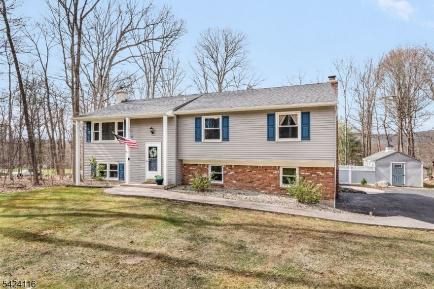 Welcome to 51 Brookwood Rd, a sprawling bi-level set on nearly 1 acre of picturesque grounds in a highly desirable location with a DREAM backyard. Set back from the road for privacy, this 4 bedroom, 3 FULL bath home impresses with a timeless brick front + newer vinyl siding. Step inside to a welcoming entry leading to a thoughtfully designed layout featuring rich wood floors + open-concept living/dining space and kitchen. Sliders extend living space to a Trex deck overlooking the expansive backyard perfect for everyday living+ entertaining. The main level offers 3 bedrooms, including a primary suite w/ walk-in closet + en-suite bath, plus 2 more generously sized bedrooms + full bath. The lower level offers incredible versatility w/ multiple living spaces: a large fam. room w/ fireplace + direct outdoor access, plus an additional rec/bonus room with Lopi wood stove. A 4th bedroom w/ its own full bath is ideal for a guest suite. Step outside to your private retreat fully fenced yard w/ newer vinyl fencing, custom-built matching shed, beautiful playset + stunning stamped concrete patio that complements the walkway for a cohesive, elevated feel. Major updates for peace of mind: Septic + roof both under 10 yrs, water heater 2 yrs. Ideally located near shopping, dining, commuter routes, hiking trails + lakes offering the perfect blend of privacy, space + convenience. This one is truly ONE OF A KIND! *Pls be sure to put in Brookwood RD in GPS, there is also a Brookwood Dr nearby*