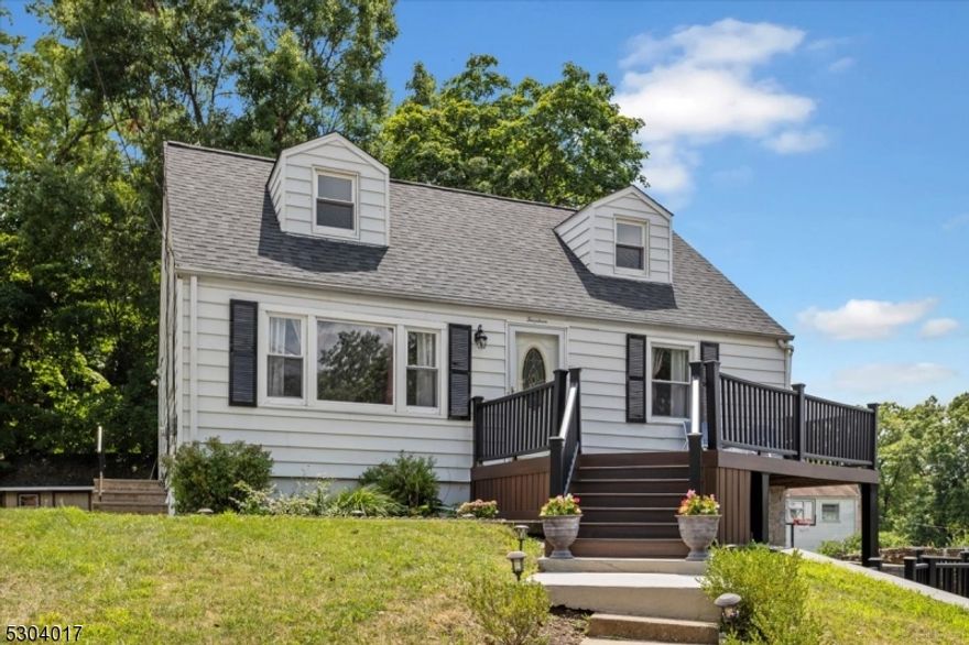 Amazing oversized and updated Cape Cod Home with 4 Bedrooms & 2 Full Baths. This home has a very flexible floor plan so the rooms can suit your needs! So many updates to mention & all are large ticket items you no longer have to think about.  A new Roof and Central Air unit was installed in 2024.In 2023 The front of the home had a multi level Trex deck & stone walls installed. A new water heater was also installed in 2023 The main floor has hardwood floors, large windows with a lot of natural light. There is 1 full bath, and the Kitchen has Stainless Steel Appliances and an exit to side and rear yard.  There are 2 bedrooms, one can be used as a dining room or you can make the dining area in the lower level  The home sits up over the road and the lower level has its own suite of rooms including a recreation room, dining room or additional living space, a guest bedroom and a full bath & separate laundry room. Another bonus is the lower level suite has its own entrance and covered porch over your own separate deck; A great use for multi generational living.  The 2nd floor has 2 bedrooms, hardwood floors and high ceilings. Move into this beautifully cared for home and just enjoy!.  Minutes with or without a car to the center of Morristown, the NYC midtown Direct Train and all the shopping, dining, theater, and nightlife Morristown has to offer.  Great location and beautifully updated home to call your own. Don't wait!  Sold As Is