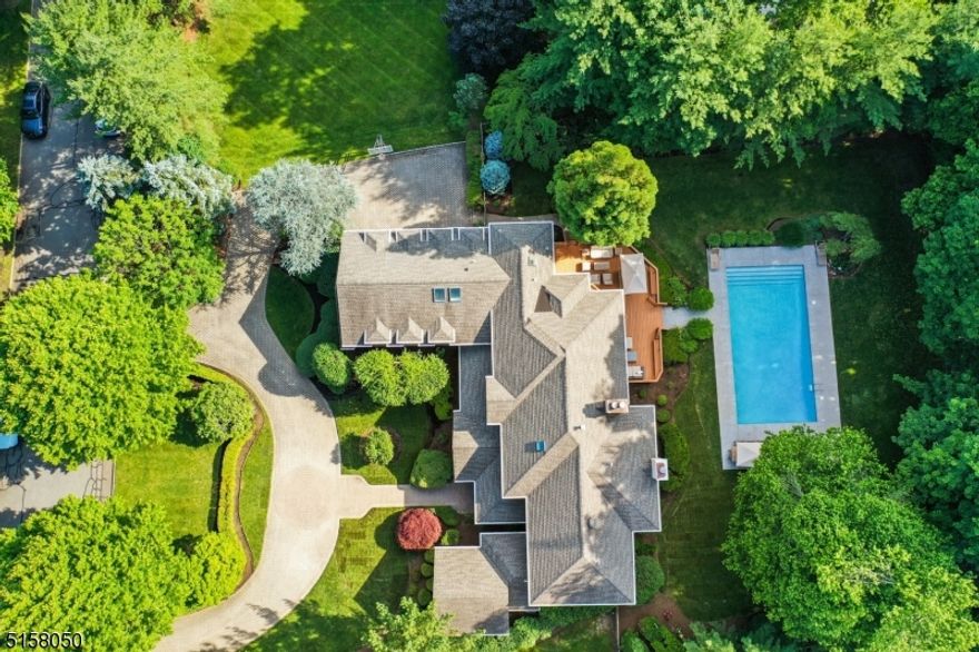 This spacious Colonial perfectly set on a sought after cul-de-sac in the prestigious Hill section of Madison rests on .71 acres of beautifully manicured property with lawns, mature trees and plantings. Truly your own private staycation, this home boasts a pool, several office options, open floor plan full of sunlight, generous bedrooms, first floor bedroom with full bath, 3 car garage, a lower level sure to wow. The lower level offers a recreation room, media room, game room, exercise room, sauna, kitchen with full bar with fridges, ice maker, sink, dishwasher and room for 8 bar stools, a full bath with steam shower and great storage. This 7 bedroom, 6.1 bath home is impressive with high ceilings, renovated kitchen thoughtfully designed with top of the line cabinets and appliances that flows into a family room with gas fireplace and breakfast room.  A large living room with fireplace and lovely open dining room, mudroom, powder room, and back stairs completes this first level.  The second floor has 6 bedrooms and 4 full baths. The large primary suite is private with gas fireplace, large walk-in closet, en-suite bath and balcony. The private yard with deck and patio offers wonderful al fresco dining, entertaining, relaxing, gardening and play. This is your perfect vacation escape in Madison voted #1 town to live by NJ Monthly.  Many updates include pool renovation with new decking, new interior surface, tile and plumbing; also a roof, furnace, and interior recently painted.