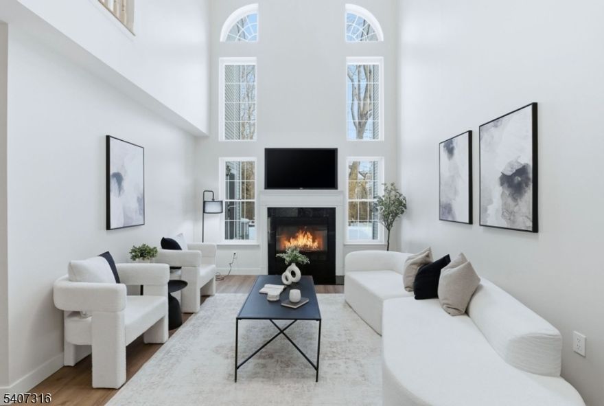 Welcome to 71 Washington Court a beautifully updated townhouse tucked within the highly desirable Jade Mountain Community in Towaco. This spacious and stylish home offers 2 bedrooms, 2.5 baths, and an attached garage, highlighted by soaring ceilings and a cozy gas fire place that sets a warm, inviting tone. Recent upgrades elevate the entire home, including new flooring, renovated bathrooms, all-new lighting fixtures, modern vanities and more. The kitchen features a large peninsula for extra seating and prep space, flowing effortlessly to your outdoor patio, perfect for morning coffee or outdoor gatherings, all while enjoying the serene, private backdrop the property backs up to. You'll also appreciate the convenient second-floor laundry room. the primary suite offers a walk-closet and a spacious en-suite bath complete with a large soaking tub, double vanity, and stall shower creating a true retreat. Ideally located just minutes from the Towaco train station, shopping, dining (including the well-known Rails Steakhouse), major highways, and daily conveniences. Plus, you're part of the top-rated Montville School District and close to the Lake Valhalla Club. A perfect blend of comfort, style, and convenience move right in and enjoy.