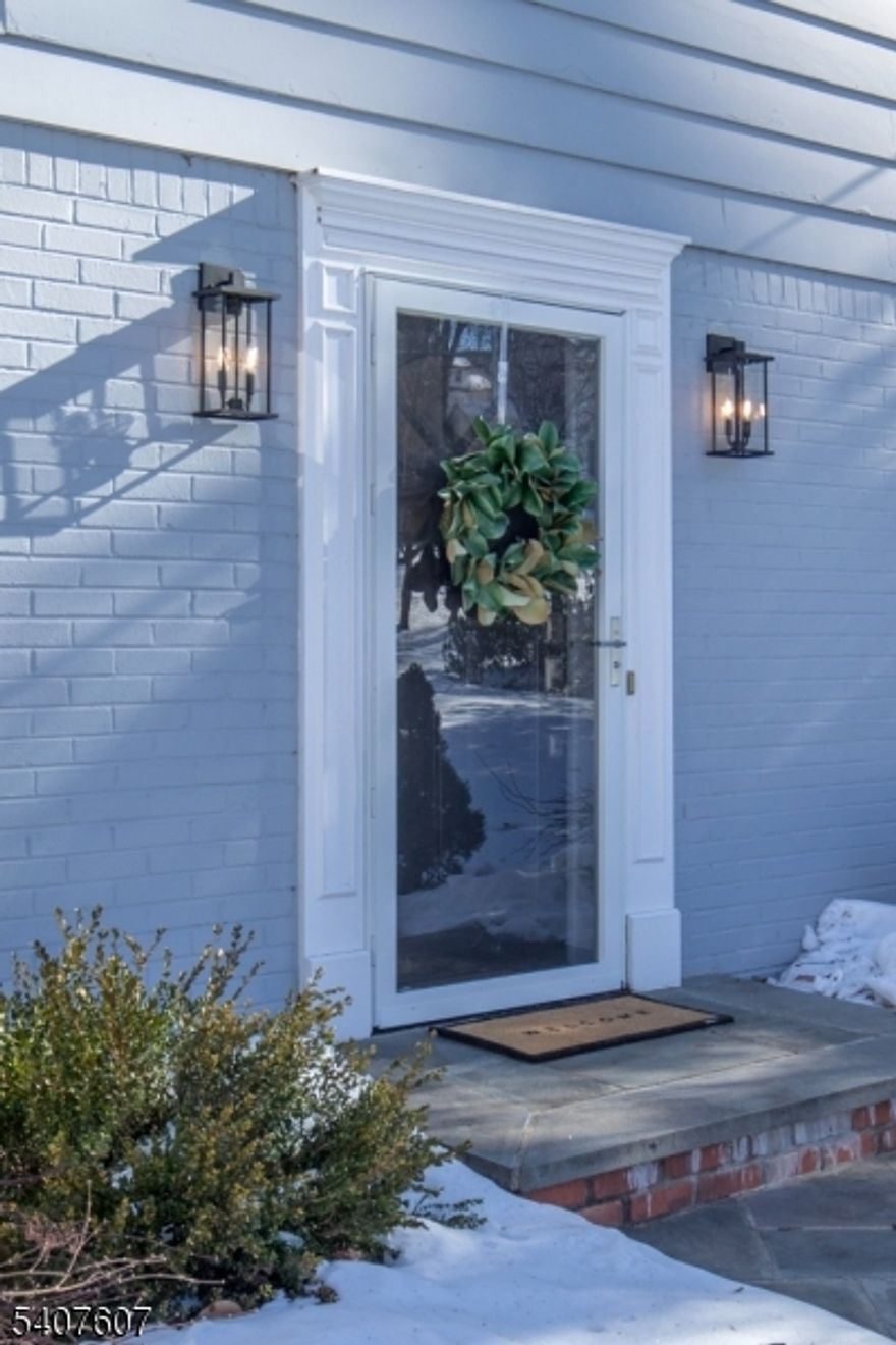 What an opportunity! Located in the desirable Spring Brook neighborhood this delightful colonial is perfectly situated on nearly 1/2 acre and backs to the 16th Fairway of Spring Brook Country Club. Lovingly maintained, this four bedroom home can be enjoyed as is or expanded. Large windows invite natural light into every room of the residence, offering the opportunity to truly enjoy the bucolic setting. A front to back living room has large picture windows at either end and is anchored by a gas fireplace with marble surround. A wonderful all season porch with window walls expands the living/entertaining space. An eat in kitchen with custom wood cabinetry and stainless steel appliances flows seamlessly into a charming seating area creating a true heart of the home feel. A more formal Dining Room adjoins the kitchen as well for easy entertaining or quiet dinners at home. Upstairs the large primary bedroom is ensuite and two more bedrooms share a hall bath. The lower level is finished to include a fourth bedroom with two closets, a full bath and a large walk out recreation room with another picture window to take in the views. A deck leads down to a large paver patio perfect for outdoor enjoyment. The level lawn stretches out to meet the lush green backdrop of Spring Brook Golf Course.