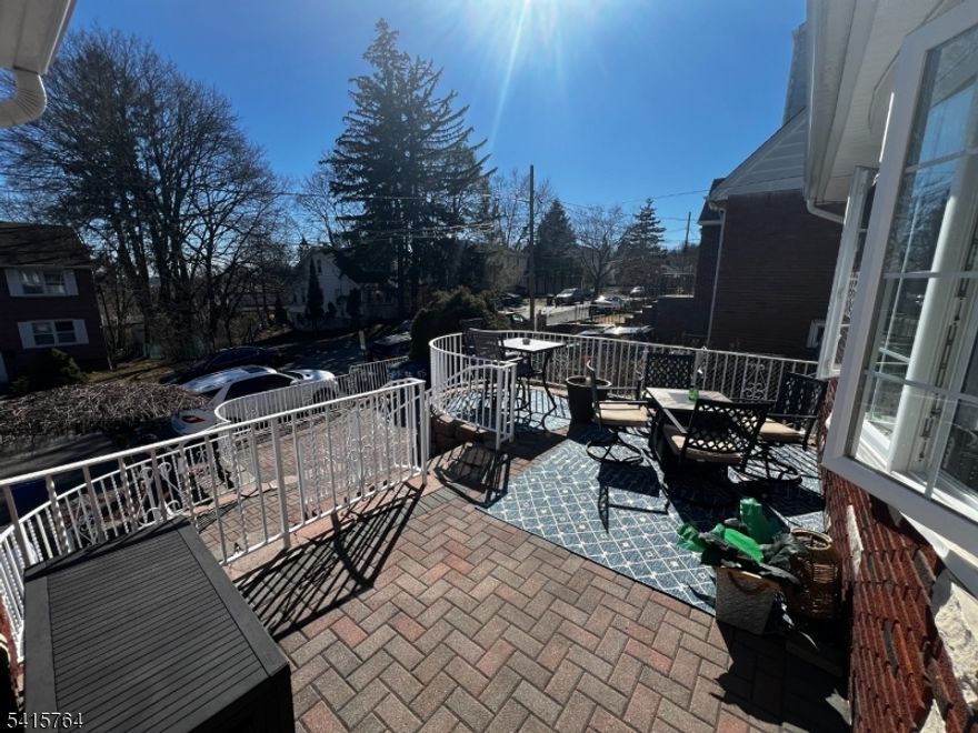 Exceptional and beautifully maintained two-family residence offering space, style, and modern upgrades throughout. This impressive property features 5 bedrooms and 3 full bathrooms, providing comfortable and versatile living. The first floor, renovated within the last five years, showcases a modern eat-in kitchen with quartz countertops, a charming coffee nook, and hardwood floors throughout, along with 3 bedrooms and 1 full bath. The second-floor unit offers 2 bedrooms and 1 full bath, with a kitchen updated in 2025. The finished basement adds valuable living space with a summer kitchen, family room, bonus room, and laundry area. Additional highlights include central air and heat throughout the home, newer windows, newer roof and siding, solar panels, water softener system, built-in speaker system, and a security system. The property also features an attached one-car garage, ample storage, and plenty of closets throughout the entire home. Enjoy outdoor living with a welcoming front terrace perfect for relaxing on summer days and a fully fenced backyard offering privacy and space for entertaining. A wonderful opportunity for owner-occupants or investors seeking a move-in-ready property with modern upgrades.Conveniently located near NYC.