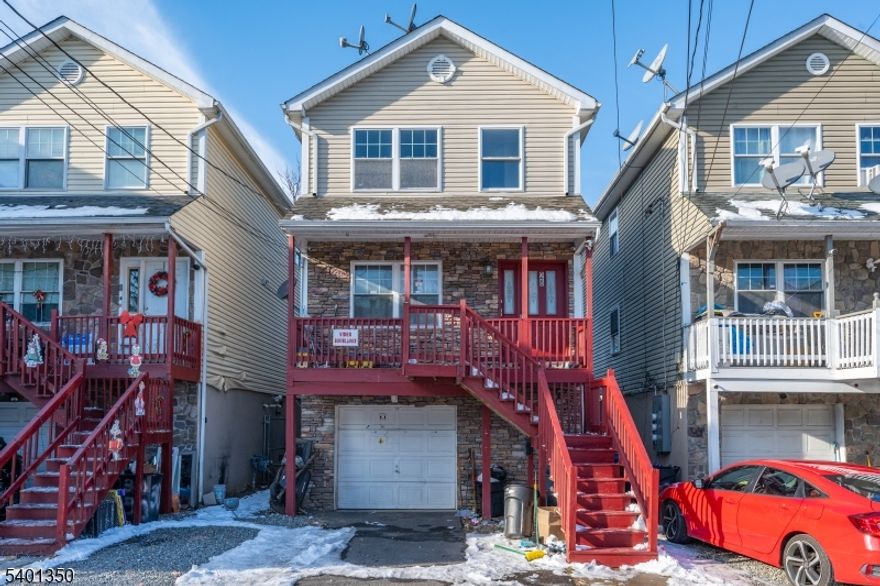 This well-kept two-family home makes a bold first impression. With its stone-accented front and elevated entrance, it offers a practical layout for both living and income. Each unit features 3 bedrooms, 2 full baths, an eat-in kitchen, a comfortable living room, and its own rear deck for outdoor space. Unit 1 also includes private access to the garage and a fully finished basement with an additional bathroom, laundry, and flexible space for storage or recreation. The property provides a one-car garage plus driveway parking for two more. Separate utilities for both units help simplify management and keep expenses straightforward. Located minutes from local shops, schools, restaurants, and the Broadway Bus Terminal with NYC access. The second unit will be delivered vacant, offering an immediate opportunity for a new lease or owner-occupancy. Don't miss it.