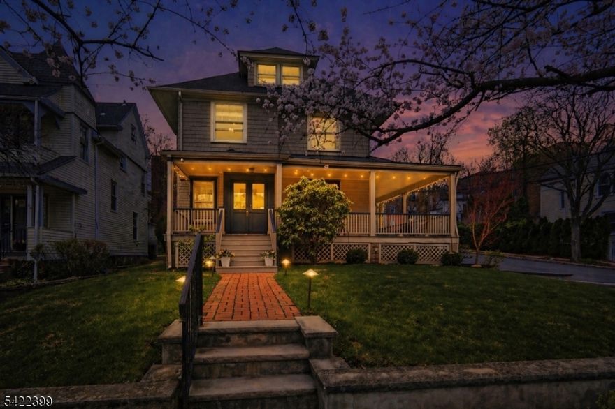 This stunning and spacious Victorian set on a corner lot, lined with charming cherry blossom trees, embodies the sought-after Montclair lifestyle, where the city meets the suburbs. Timeless architectural details greet you at the wraparound porch before entering the double-door vestibule, leading to a grand foyer and impressive staircase. Rich in historic charm - crown moldings, decorative trim, stained glass windows - all thoughtfully integrated with modern updates. Custom built-ins frame the formal study, flowing seamlessly into the dining room with stunning fireplace and large windows that fill the space with natural light. Bright, inviting kitchen offers stainless steel appliances, quartz countertops, and a breakfast bar that opens to a relaxed living area. Full bath and powder room complete the 1st floor, ideal for entertaining. The 2nd floor features four bedrooms and two full baths, including oversized primary, while the 3rd floor offers two additional bedrooms perfect for guests or home office, plus a large walk-in storage room. Basement includes addtl. storage, gym space, laundry, and utility areas. Outside, a serene private patio and gated yard w/ fountain and lush landscaping evoke an English garden. Rare 3-car garage, paved driveway, and bonus shed provide ample parking and storage. Ideally located near the Library, Wellmont Plaza, Chvrch Street, Montclair Center, Bay St and Walnut St NJ Transit. This lovingly maintained 1897 home is a true architectural gem!