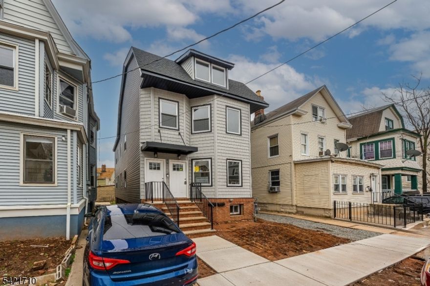 Welcome to 16 Headley Terrace, a fully gut-renovated two-family home perfectly situated on the Maplewood border, one of the most desirable locations in the area. Renovated in 2025 from top to bottom, this is a rare opportunity in a neighborhood where properties seldom come to market.The first-floor unit offers 3 bedrooms and 1 full bath across 990 SF, featuring an open kitchen with white shaker cabinets, quartz countertops, stainless steel appliances, subway tile backsplash, and beautiful wood-look porcelain flooring throughout. The second-floor unit is truly a standout, spanning two levels with 5 bedrooms and 2 full baths, featuring its own full kitchen, generous room sizes, and a stunning third-floor primary suite with panoramic windows and abundant natural light. Both units share the same high-end finishes including marble-look tiled bathrooms with matte black fixtures, recessed lighting, and brand-new central air and forced hot air systems. The expansive unfinished basement presents tremendous additional potential. A shared driveway will be fully paved with blacktop prior to closing, adding everyday convenience and completing this turnkey package. Commuting is effortless with Route 78, GSP, and NJ Transit all minutes away. Whether you are an investor seeking strong rental income or an owner-occupant wanting to live in a premier location while generating cash flow, this property truly delivers.