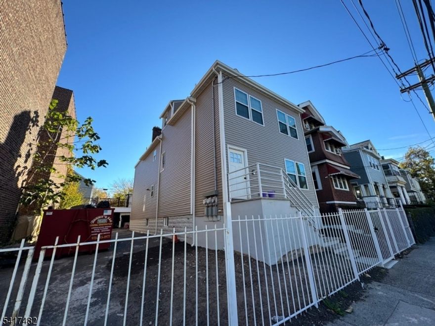 Rare opportunity to own a fully renovated 2-family home with exceptional bonus space and flexibility. Property features a spacious finished attic with full bath and 2 versatile rooms, plus a finished basement with private entrance, 3 additional rooms, and a full bath, offering an impressive amount of usable space for recreation, workspace, guest use, storage, or other permitted uses. Each main unit offers 3 bedrooms, 3 full baths, full kitchen, living area, and in-unit laundry. Renovated approximately 1 year ago, the home showcases central heat and central AC, granite countertops, stainless steel appliances, ceramic tile baths, and modern fixtures. Each unit also includes 2 bedrooms with en-suite baths and walk-in closets. Outside features include a large private driveway with parking for up to 6 cars, plus a huge 3-car garage. Conveniently located near major transportation, highways, and Downtown Newark. Buyer to verify all information and permitted uses.