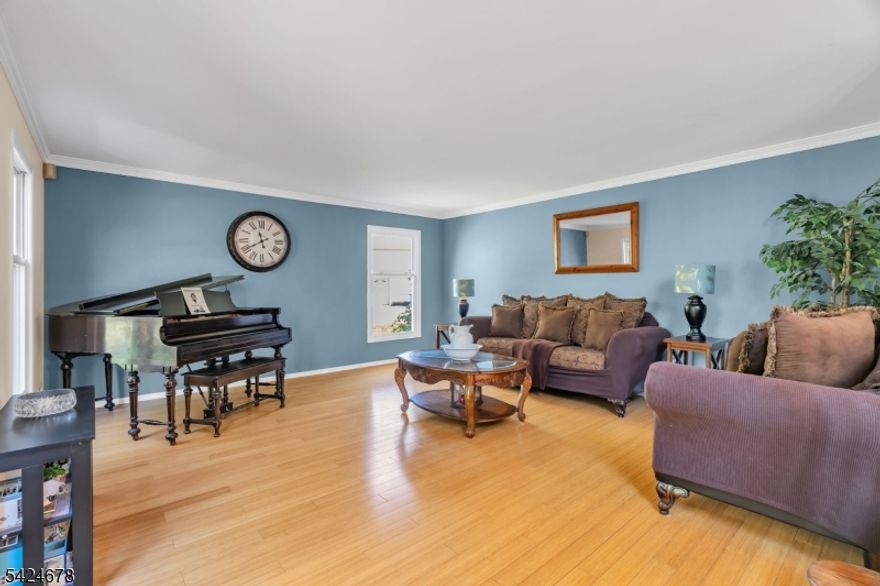 Impressive Center Hall Colonial offering the perfect blend of space, comfort, and seamless indoor-outdoor living. A dramatic two-story foyer with vaulted ceilings and elegant marble tile creates a striking first impression, while the open hallway above offers a beautiful overlook to the entry below. The main level features a spacious living room, formal dining room, and an updated eat-in kitchen with crisp white cabinetry, flowing effortlessly into the inviting family room perfect for both everyday living and elevated entertaining. A convenient powder room and first-floor laundry complete the main level. Upstairs, four generously sized bedrooms and two full baths include a luxurious primary suite with a spacious walk-in closet and a beautifully appointed bath with soaking tub and separate shower. A finished basement adds valuable flexible living space, ideal for recreation, work, or relaxation. Designed with entertaining in mind, the family room opens to a bright three-season room, while the kitchen also provides direct access to the expansive multi-level deck. The outdoor setting is truly exceptional, featuring a covered bar with three-sided access ideal for hosting overlooking a large heated pool for endless summer enjoyment. A rare offering that seamlessly blends classic elegance with exceptional indoor and outdoor living.