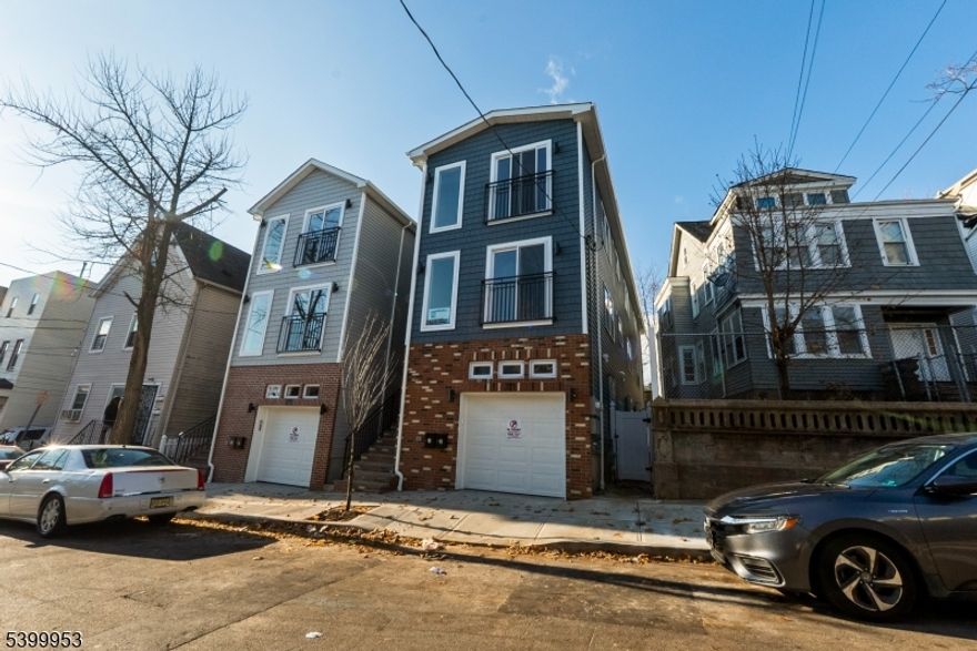 Seize this opportunity to own a brand-new, masterfully designed two-family home that delivers unmatched versatility. This residence offers a total of six bedrooms and four-and-a-half bathrooms, complemented by a level, fenced-in yard perfect for outdoor enjoyment. Each unit showcases modern open-concept layouts and expansive windows that flood the interiors with natural light. The first unit features three bedrooms, two-and-a-half bathrooms, a recreation room behind the two-car garage, and a primary suite complete with a walk-in closet and its own bath. The chef's kitchen boasts quartz countertops, stainless appliances, and a generous island designed for hosting. The second unit offers three bedrooms and two full bathrooms, making it an ideal option for rental income. Both units provide private entrances, separate utilities, and in-unit washer/dryer combos for ultimate convenience and privacy. Additional highlights include hardwood floors, central HVAC, energy-efficient systems, ample storage, a two-car garage, and an intercom system. Situated in a vibrant, commuter-friendly neighborhood close to schools, shopping, dining, and public transit, this home is an exceptional choice for investors or owner-occupants seeking luxury, flexibility, and long-term value. To top it off, the property comes with a builder's warranty and a five-year tax abatement, offering significant savings for homeowners. Don't miss out this is more than a home, it's an investment in your future.