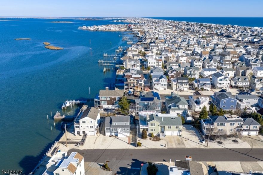 Perched in a scenic setting in Long Beach Township, this 4-bedroom home offers panoramic views and a layout designed to embrace its natural surroundings. Enjoy sweeping vistas from the multi-story deck, perfect for entertaining, relaxing, or simply taking in the coastal beauty. The oversized yard provides rare outdoor space, ideal for gatherings, play, or future enhancements. Inside, the primary suite is a true retreat, featuring a large sitting room that adds flexibility for a home office, reading lounge, or private escape. Set in one of Long Beach Island's most desirable townships, the home benefits from close proximity to beaches, bay access, and miles of shoreline, while still offering privacy and elevation that enhance views and breezes. A special opportunity to own a home that combines space, scenery, and the laid-back luxury of LBI living.