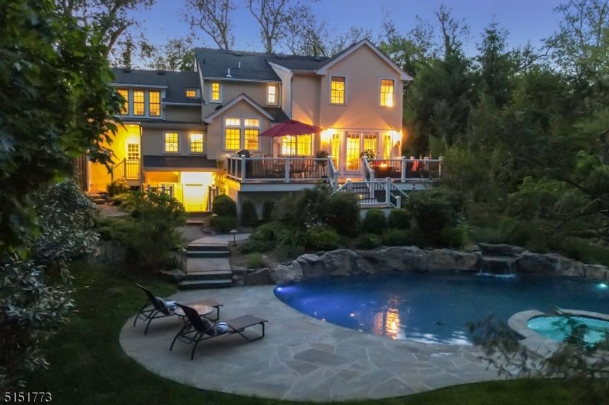 Own your own Personal Paradise! Located on a prestigious and serene street in Short Hills. Steps away from Downtown Millburn, Highly Rated Schools, & New York City Commute. This graceful home is EXPANDED AND RENOVATED IN ITS ENTIRETY by the current owners in 2013-14. The first floor offers excellent flow; Living room with plenty of natural light & a gas-burning fireplace, a quintessential sun-lit family room, and French doors leading to an Expansive Composite Deck overlooking a picturesque backyard; Open-Concept 2014 built kitchen offering a chic large center island, top-of-line gourmet appliances, bar/prep area, informal dining area, & plenty of storage space; a formal dining room just off the kitchen is perfect for entertaining. 1st floor also offers a powder room and mudroom with heated floors providing uninterrupted access to a 2 car attached garage. The second floor offers an expansive primary suite with walk-in closet, a luxurious marble primary bath with heated floors adorned with double vanities, jetted tub, and a luxurious shower. 3 more bedrooms and a fully renovated hall bath with heated floors complete rest of 2nd floor. Fully finished walk-out basement with home theater and rec-room set-up, large laundry room, home office, playroom, half bath, storage, & workshop. An exquisite IN-GROUND GUNITE POOL with mood lighting and wirelessly controlled waterfall, and Tennesse sandstone deck built by the renowned Inca Pools in 2016 makes this home absolutely irresistible.