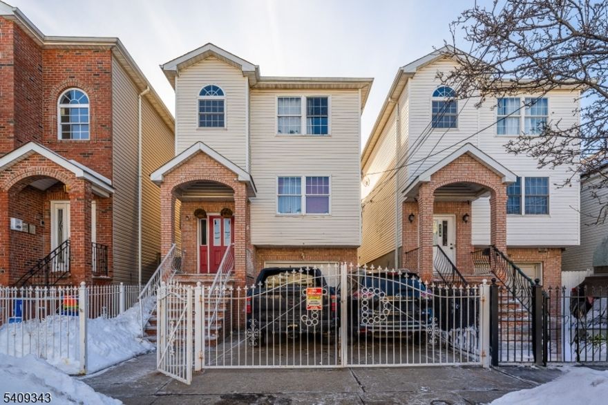 Well-maintained two-family home built in 2006, Owner-occupied and lovingly cared for. Each unit offers 3 bedrooms and 2 full bathrooms, including a primary bedroom with a full en-suite bath. Hardwood floors throughout, central air and heating that where both updated on 2024 and 2025. Laundry room available in both floors. Finished basement with a full bathroom, separate side entrance, and direct access to the garage offers additional flexible living space. Attached garage plus a two-car driveway provides ample parking. Fenced backyard with gazebo included. Conveniently located near Newark Liberty International Airport, bus transportation, shopping, and local amenities.