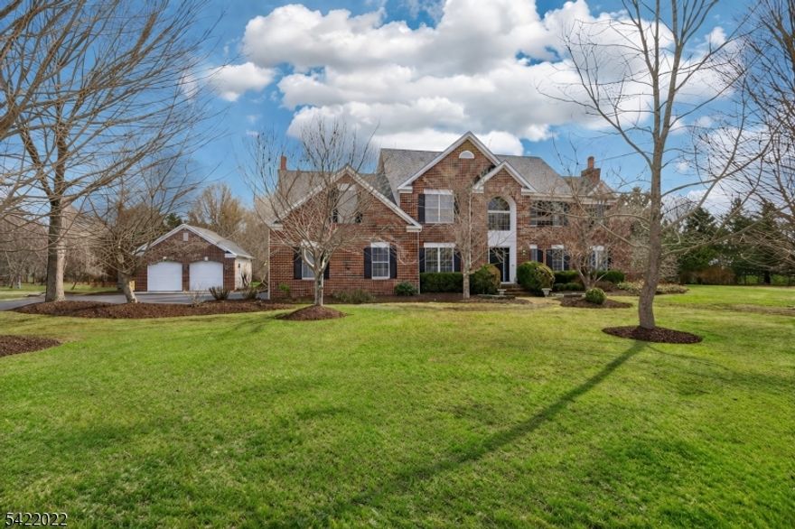 An exceptional opportunity to own in sought-after Homestead Farms, this classic Brick Colonial is a showstopper. From the moment you arrive, the home's timeless design and refined feel set the tone. A 2-story entry welcomes you with Italian ceramic tile flooring and introduces beautifully proportioned rooms designed for both everyday living and entertaining. The eat-in kitchen is thoughtfully designed with stainless steel appliances, maple cabinetry, quartz countertops, and subway tile backsplash, blending function and style. The main level features a sophisticated dining room with rich oak flooring and a striking mahogany surround, an expansive great room with a wood-burning fireplace, a light-filled formal living room, a den with a wood-burning fireplace and a Texas limestone surround, and a dedicated home office with custom-built-ins. Upstairs, the primary suite is a private retreat with an oversized sitting room, a walk-in closet, and an updated en-suite bath with a spa-like feel. Three additional bedrooms and a bonus room provide versatility. A large unfinished basement with high ceilings offers exceptional potential for customization. Enjoy the covered rear porch with Trex decking, overlooking the expansive, private grounds. Additional features include a carriage house with a two-bay garage and a Kohler generator. Set in a picturesque, leafy neighborhood minutes from Route 80, this home is truly special and not to be missed.