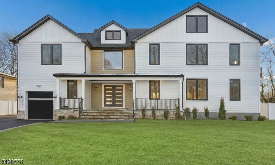 A striking statement of modern luxury, this extraordinary Custom-Built Colonial on existing foundation rises in one of Westfield's most desirable neighborhoods, offering exceptional craftsmanship and a breathtaking open layout filled with natural light. Dramatic windows, refined millwork & rich hardwood floors set the tone for a home designed to impress at every turn. The chef's kitchen is a true centerpiece, showcasing quartz countertops, an expansive island, custom cabinetry & top-tier appliances including a 6-burner stove & pot filler, seamlessly opening to the family room with electric fireplace & access to the fenced backyard and patio. The first floor also features a sophisticated living room and dining room with built-in bar, private home office, guest suite with full bath, powder room, & mudroom. Second floor unveils a show-stopping primary suite with balcony, electric fireplace, custom walk-in closet, and spa-like bath, along with a princess suite, two additional bedrooms, two full baths & laundry. The third floor offers a sixth bedroom, full bath & multi-functional bonus room, while the finished basement with walk out adds another recreation room & half bath. Forward thinking with tankless hot water heater, EV charger in garage & Cat 6 cable wiring throughout. A rare offering that embodies elegance, comfort, and elevated living, this remarkable home presents a truly unparalleled opportunity to live beautifully in Westfield. Make this exceptional home your new home!