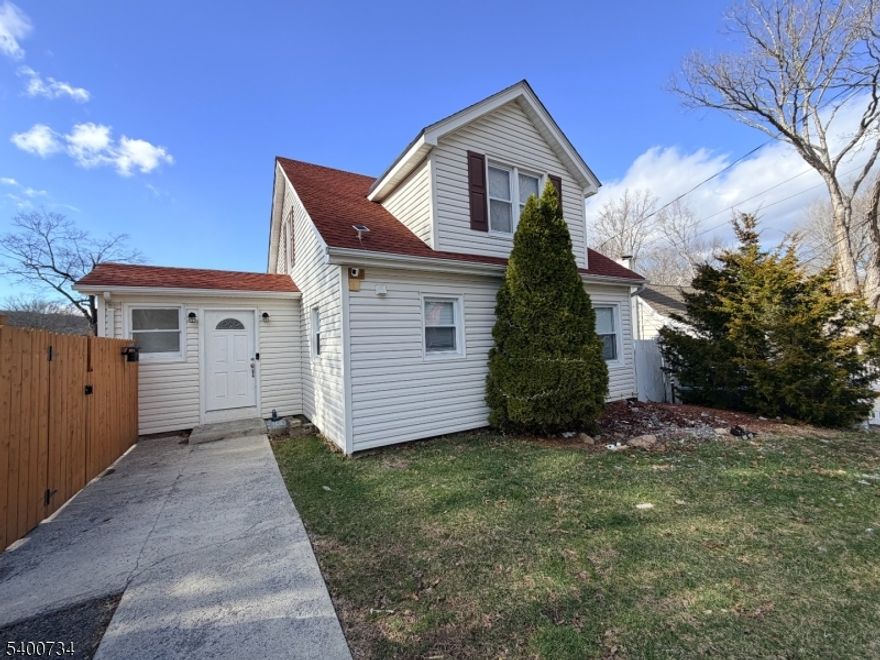 Charming Move-in Ready Cape! Don't miss this fantastic opportunity to live just minutes from the lake. Step inside to an inviting open kitchen featuring granite countertops, a breakfast bar, and stainless steel appliances. The dining area, accented by a cozy wood-burning fireplace, creates the perfect setting for everyday living or entertaining. The beautifully updated bathroom boasts modern fixtures and a spacious, stunning tiled shower. A convenient first-floor bedroom offers flexibility for guests or a home office. The bright living room opens to an upper deck through sliding doors, complete with built-in seating creating the ideal spot to relax outdoors while enjoying stunning lake views! Upstairs, you'll find two additional bedrooms with generous closet space, and additional storage/office space. The fully finished walk-out basement adds even more versatility, offering two additional rooms for den/family room/office/storage, and another spacious bathroom. Enjoy your private fenced-in backyard perfect for cozy evenings under the stars. Newer furnace, water softener, and solar panels make this home truly unique while significantly reducing electric costs. Located close to major highways 80, 46, and 23, this home delivers the perfect blend of comfort, convenience, and value. A must-see!