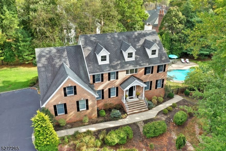 Set at the end of a coveted cul-de-sac on 1 acre of professionally landscaped park-like property, this stately 5 bedroom, 4 full bath brick-front colonial is a true oasis. Enjoy gorgeous hardwood floors, spacious rooms, open flow, many recent updates, abundant windows & ample storage throughout. Grand entrance foyer opens to the formal dining rm. or sun-filled living rm. Recently updated eat-in kitchen features top-notch stainless steel appliances, 2 ovens, quartz counter-tops, breakfast bar, abundant cabinetry, pantry & separate eating area w/ sliding glass doors out to a private paver patio & fenced back yard. Spacious family rm. is open to the kitchen & offers walls of windows, built-in shelves & wood-burning fireplace. A 5th bedroom or home office, updated full bath & mud room w/direct access to the attached 3-car garage complete the first level.  Second floor private spaces include 3 more sizeable bedrooms, updated full hall bath w/double sinks & laundry room. Luxurious primary bedroom suite includes an expansive custom walk-in closet, private sitting rm. or home office & vast spa-like updated full bath w/jetted tub, double vanity, glass enclosed shower, vaulted ceiling & skylight. Fabulous finished basement hosts, game & recreation rms. a 4th full bath, utility & storage areas. Heated in-ground pool & designated fire-pit area make this special home ideal for daily living, outdoor enjoyment & year-round entertaining. Close to Franklin School, town & NYC transportation.