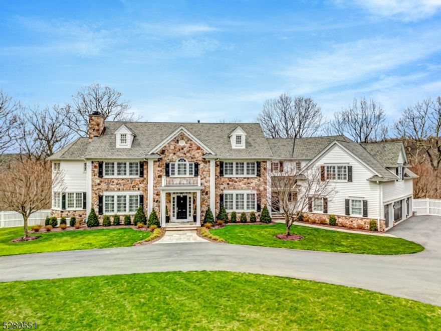 Grandly displayed at the apex of one Bernardsville's most desirable neighborhoods, this 6000+sq. ft. estate residence readily displays its exemplary luxury and sophistication. Magnificentupon completion, the home was recently brought to perfection with an infusion of $300K forinterior/exterior decor and groundskeeping. High ceilings, walls of windows, and volume spaces, each with impeccable style and highest quality finishes, engage the senses. The Great Room with coffered ceiling soars. Take in the vast grounds from the serenity of the sunroom or the office/library. Among the kitchen's superlatives are white finishes, professional grade appliances, 9-ft island, beverage bar. The breakfast room is a window-filled hexagon with turret ceiling. Throughout are frequent French doors, thick layered crown moldings, oak floors, multiple fireplaces, plantation shutters at windows and doors. Upstairs the exemplary Primary Suite includes sitting and dressing rooms, the latter with spacious walk-in closets. There are 4 additional ensuites including a guest/in-law suite with living room. The finished walk-out lower level adds 1600 sq. ft. of living space including a recreation room, bar room, full bath and the home's 6th bedroom. Stairs ascend from this level to the 4-baygarage. Outdoors a wrap-around deck sweeps the home's rear. The view is to acres of forested stillness and privacy. Welcome to a rare gem perfectly poised for the next discerning owner to cherish and enjoy.