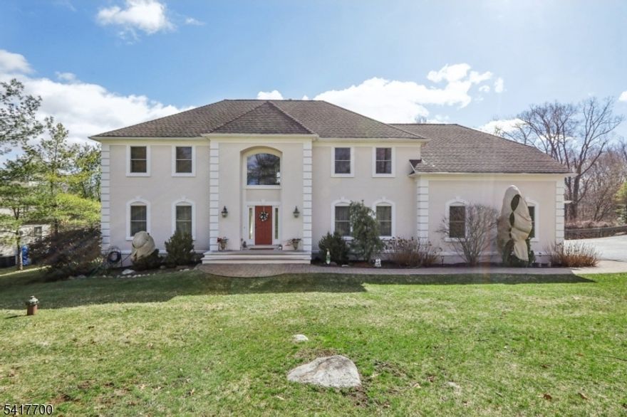 Stunning Colonial set on approximately 3 acres offers an impressive two-story Entry Foyer with dual closets, Formal Dining room accented with crown molding and chair rail, Living room that flows into the Family room with a gas fireplace. The spacious Modern Eat-in kitchen features a center island, separate dining area, top-of-the-line appliances, pantry, and sliders leading to a large deck that's perfect for entertaining. The first level also includes a Powder room, mudroom, and access to the 3 car garage. The second floor features a large Master Bedroom with tray ceilings, spacious California walk-in closet, and luxurious Bath with dual vanity and jetted tub. Three additional generously sized Bedrooms include one with a private full Bathroom, along with a Laundry room and an additional full Bathroom. The fully finished walk-out basement with high ceilings offers a second family room, game room, exercise area, office, fifth bedroom, and full Bathroom. Enjoy outdoor living in the private backyard featuring large deck with gazebo and hot tub, patio, fire pit, swing set, and storage shed. Located in desirable Kinnelon, known for its top-rated schools, and conveniently close to shopping, dining, parks, golf courses, hiking trails, major highways, and just 35 miles from New York City.