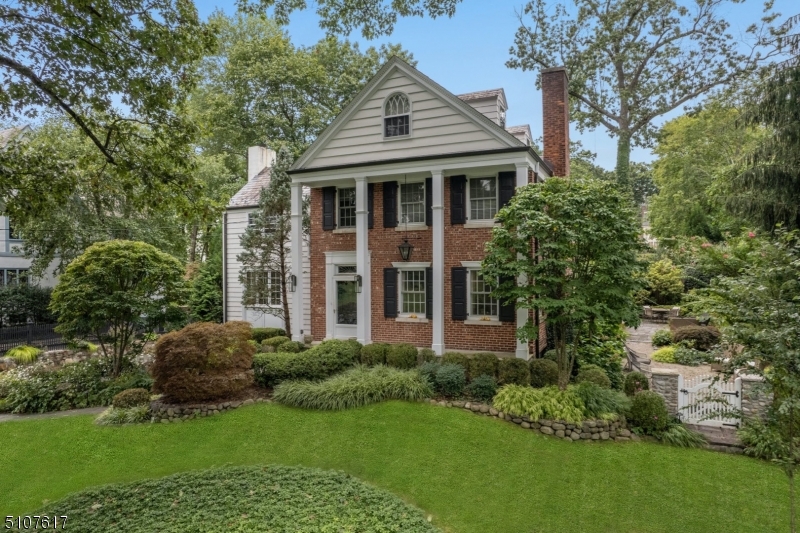 Nestled in the heart of Summit's Northside, this stately brick and shingle Colonial with slate roof offers 5 bedrooms, 4.1 baths, large rooms and oversized windows drenching the home in natural light. Guests enter a grand two-storey entry hall with palladium window providing access to an oversized fireside Living Room, Family Room, Powder Room, generous Dining Room and upscale Kitchen.  Front and back staircases lead to the second floor with four Bedrooms including the Master Bedroom Suite. Both the Hall Bath and Master Bath are recently renovated with spa like features.  The third floor offers private space including a bedroom which could also function as an in-home office and newly renovated Bath. The lower level includes a Gym, Mud Room, Full Bath, Laundry, recently renovated Recreation Room and access to the two car Garage. The professionally landscaped and lovingly maintained grounds offer privacy and include a deck, bluestone patio and pebble patio.  An in-ground sprinkler system ensures that the mature landscaping thrives.