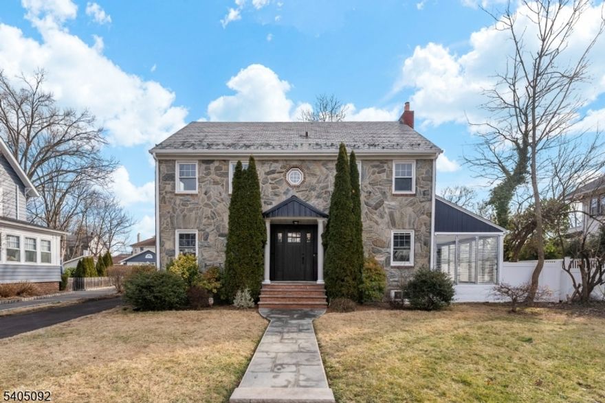 With renovation just completed in 2026, this large 3 level property is set on a quiet, tree-lined street in the coveted Tuxedo Park section of South Orange. This stately stone Colonial with fireplace offers timeless charm, and generous space. With six bedrooms (two with en-suite bath) totaling four-and-a-half baths, the home feels both expansive and inviting, equally suited for vibrant family life or a buyer seeking room to grow, work, and entertain with ease. A glassed-in sunporch provides a peaceful retreat for morning coffee or quiet evenings, and a finished basement with full sized entrance adds flexible space for recreation, work, or relaxation. A rare three-car garage and large driveway enhance both convenience and functionality