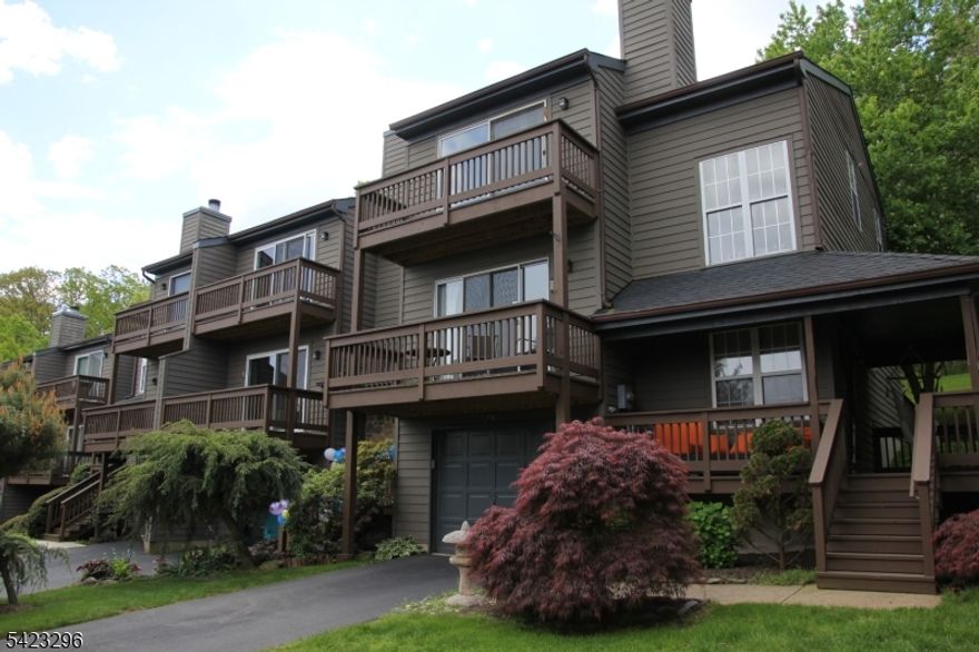 Welcome to the beautiful 2-bedroom townhome sitting at one of the best locations in Montgomery Woods.     At the main level, there is a large open living and dining room, with a fireplace and double patio door to the front balcony.  The kitchen has cherry wood cabinets, granite counters, SS appliances with 2025 dishwasher, range and oven, and 2023 refrigerator.  There is also a large walk-in pantry.  From the kitchen through the patio door, a large deck is at back of the house.  It is facing to the Autumn Hills Preserves.   The two bedrooms are at the upper level with nice view, each has its own full bath, walk-in closet. The lower level is finished with laundry of 2025 washer and dryer, and an entrance door from the oversized one car garage.  It is at highly ranked Montgomery School, close to downtown Princeton, shopping, and easy to access route 206 and route 1.