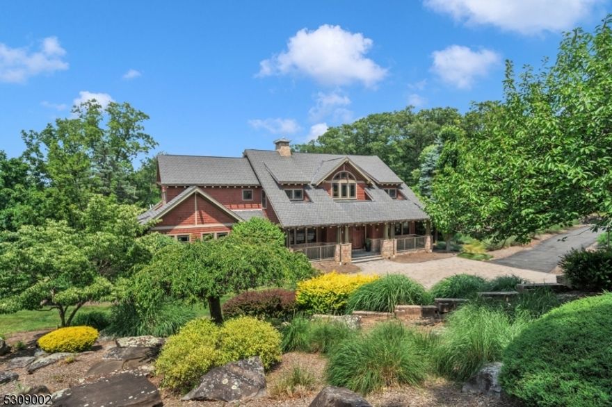 Nestled at the end of a tranquil cul-de-sac on almost 3 acres in the prestigious Valhalla Ridge, this stunning Craftsman-style home offers over 6,000 square feet of luxurious living space, not including the expansive fully finished basement. This residence exemplifies refined elegance and comfort. Upon entering, you'll be greeted by an open floor plan with soaring vaulted ceilings, custom trim work, and an abundance of natural light. The gourmet kitchen, a chef's dream, features top-of-the-line appliances, ample cabinetry, and a spacious island with waterfall edge, making it perfect for both everyday meals and entertaining guests. The first-floor primary bedroom is a private oasis, complete with two walk-in closets, a dressing room, and an en-suite bath featuring a jetted tub and a steam shower. The additional four bedrooms, on the second floor, are generously sized, each offering comfort and privacy. The fully finished basement is a true highlight, boasting a second kitchen, full bathroom, multiple versatile rooms, and its own private entrance ideal for an in-law suite, guest quarters, or a luxurious entertainment space. Step outside to enjoy the serene outdoor living spaces, including a deck and a patio, perfect for alfresco dining or simply unwinding in your private retreat. This exceptional home in Valhalla Ridge offers the perfect blend of luxury, functionality, and tranquility, making it a must-see!