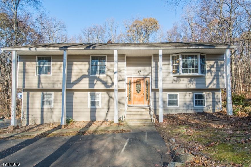 PROFESSIONALLY CLEANED TOP TO BOTTOM, INSIDE AND OUT, PROFESSIONALLY LANDSCAPED & PROFESSIONALLY POWER WASHED (siding & roof). Lots of Generous Room Sizes to Spread Out & Make Your Own! Layout offers versatile options! Ground level IN-LAW SUITE w/sep entrance & full kitchen! GREAT house for entertaining or everyday living. Hardwood Floors. Great living space w/wood burning stove. Oversized family room w/high ceilings appointed w/custom palladian windows & sliding glass doors leading to 2 story, trex style deck. Super functional kitchen w/NEW SS appliances, quality wood cabinets, granite & bfast bar. Opens to dining & living areas. 3 large bedrooms & 2 full bath upstairs includes the master suite w/private access to the back deck. 4th bedroom & bath on lower level. Fully equipped in-law suite on ground floor w/sitting area & walkout to backyard. Over 2500 square feet. Heated 2 car garage w/workshop. Plenty of storage space in the attic, garage or storage shed. The backyard is large, level and private. Over a full acre. Above ground pool. An ideal spot to relax & enjoy life. Just a 5 min drive to the bustling Downtown, NYC Direct Mass Transit & easy access to major highways such as 80, 10, 46 &287. Affordable taxes especially for home size. Anderson double pane windows & exterior doors. Top rated schools. Amazing opportunity & Value. MAKE AN OFFER!