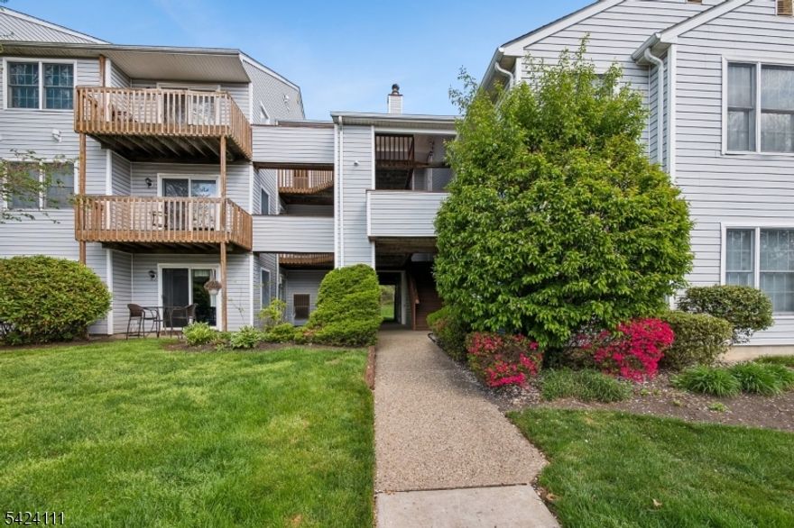 Absolutely Pristine, sun-filled, truly move-in ready 2 Bedroom condo in desirable Pine Brook Village! With over $50,000 in upgrades, this home offers exceptional value & high end upgrades include new furnace, new hot water heater, kitchen & bath upgrades, new flooring & recessed lighting throughout. Enter into a bright, open floor plan featuring a spacious living and dining area & updated kitchen w breakfast bar. The kitchen boasts granite, all stainless appliances, new flooring, freshly painted cabinetry w gold hardware & faucet, new dishwasher, added ceiling fan & recently opened layout for enhanced light and flow. Custom picture frame molding enhances both the living room and primary bedroom, adding elegant character and detail. Enjoy a premium location with serene wooded views from your private balcony, complete with newer sliding glass door, upgraded faux deck flooring and a bonus storage closet. The primary bedroom offers a custom walk-in closet & ceiling fan, while the second bedroom is generously sized with wooded views. The full bath has been tastefully updated with new tile flooring, vanity, mirror, and toilet. Additional features include a full-sized in-unit LG washer and dryer, custom blinds & extra utility storage room. Conveniently located near NYC transportation and major highways, shops, dining & great schools. This well-maintained community also offers a beautiful pool and playground. Steps to Lincoln Park Elementary, parks & Meadows Golf Course. A MUST SEE!!