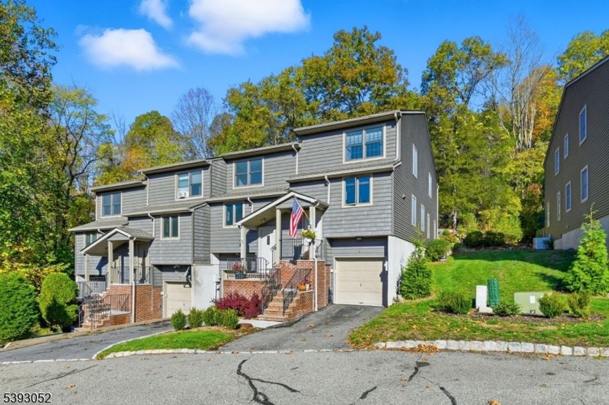 Beautifully refreshed, light and bright interior unit at desirable Mountain Ridge Townhomes in Bloomingdale, NJ! Fully repainted in White Dove and ready for your design inspo! First floor with new white oak wide plank Aquaguard Performance floors. Kitchen with new stainless appliances, granite counters, and separate dining area. Formal dining room to sunken living room with fireplace and slider to deck overlooking multi-tiered gardens. Updated half bath rounds out the first floor. Second floor with brand new lush berber carpet. Hallway laundry closet. Spacious primary bedroom with multiple closets and fully renovated primary bath with subway tiled stall shower. Bedroom 2 with oversized double closet with built-in organizers. Main hall bath with new vanity, and tub shower. Unfinished full basement with utilities - ready for your ideas - and access to oversized attached garage with ample storage and plenty of room for a car + motorcycle! Sellers' contractor open to finishing basement for Buyer after closing.