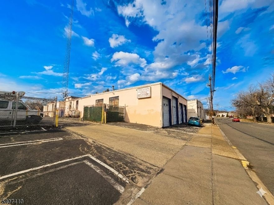 Rare opportunity to secure a premier 7,000 SF professional flex facility in the heart of the prestigious Springfield/Short Hills corridor. Designed for the modern 2026 logistics landscape, this property offers unrivaled vehicle capacity and operational flexibility.The site features a rare 23 total vehicle stalls (19 surface spaces + 4 internal garages), providing a 320% parking surplus that is ideal for high-staff medical clinics or fleet-heavy service contractors. Logistics are optimized with five  high-clearance drive-in bays, including an oversized 12' door for high-roof Sprinter vans and four 10' bays for standard fleet vehicles.The interior boasts a turn-key professional wing with two private offices, allowing management to operate seamlessly alongside warehouse or showroom activities. Five distinct access points facilitate a high-efficiency circular workflow, while the flexible footprint is easily divisible for scale-up tenants (3,000"5,000 SF). Minutes from NJ-24, I-78, and the GSP, this high-visibility facility offers significant signage opportunities in a high-wealth demographic area.