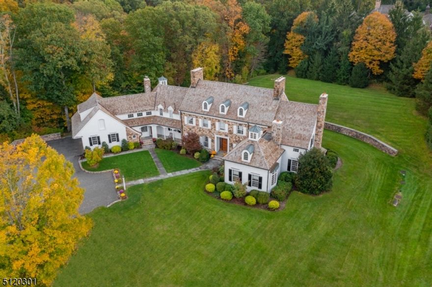 Gracious Custom Home in prime section of New Vernon in Harding Township nestled on 3+ acres of beautifully landscaped private magnificent property on highly sought after Holly Hill Lane. Classic beauty with white clapboard and stone and new gorgeous cedar wood roof.  The interior features 6 Bedrooms and 6 bathrooms with over 7400 sq ft of living space and numerous custom features ,materials ,and details. Also many updated features and lighting throughout. Gracious 2 story entryway with grand staircase.Expansive gourmet eat-in kitchen with huge breakfast area boasts high end 6 burner range, 2 dishwashers, huge refrigerator/freezer, quartz counters, and gorgeous porcelain tile floor and opens to large FR with stone wood burning FP and pickled cedar walls and dramatic cathedral ceiling with cupola.  Huge dining room and living room with wood burning FP and French doors to patio.  Large wet bar on first floor and gorgeous library with gas FP and coffered ceilings. Also on 1st fl is a private bedroom suite and laundry and 3 car garage. Second floor has 5 bedrooms and 3 full baths. Primary suite is huge with multiple closets, and huge bath with jetted tub, stall shower, dual vanities and french doors to private balcony.  Also on second level 4 large Bedrooms and 2 full baths, huge rec room, and tons of storage.  Large 3 car garage with outdoor attached shed, large private patio and private tranquil setting.  Huge lower level offers endless possibilities for additional living space.