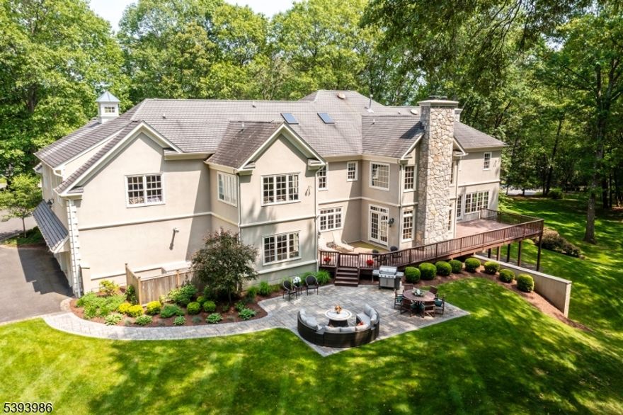 Welcome to this stately 5 bedroom, 5.2 bath Collie Mannion custom colonial, set on quiet cul-de-sac street. This 7,300 sq/ft beauty located on 5.46 acres has many attractive features, incl. 9+ foot ceilings, 4 FP's, arched doorways & HW floors throughout. Enter the gracious mahogany front doors to the 2-story entry foyer w/ sweeping, curved staircase. The enchanting,18-ft high Great Room w/ floor to ceiling stone FP, custom mahogany office w/ coffered ceiling, new bar room w/ custom built, full-length, mahogany Subzero wine fridge & dry bar are some of the stunning attributes. Other exceptional details incl. lg, light-filled kitchen w/ oversized breakfast rm, butler's pantry, walk-in pantry w/ custom shelving & back staircase to 2nd floor. Upstairs, the primary suite boasts a cozy sitting room w/ FP, a lg bath & 2 WICs. An additional 2 en suites, one w/ charming sitting rm, grace the 2nd floor, along w/ 2 additional bedrooms w/ a J&J bath & large laundry room w/ drip dry station. With a 6-bedroom septic, the walk-up attic has tremendous possibilities for more finished space. The finished, W/O basement incl. an entertainment rm, billiards/rec rm, a full bath & lg storage & utility areas. French doors to paver patio allow you to continue the entertainment outside. Three sets of French doors offer access to ample back deck, where you can commune w/ nature in this beautiful, private setting. This lovingly cared for home w/ whole house generator & heated garage is a true find!
