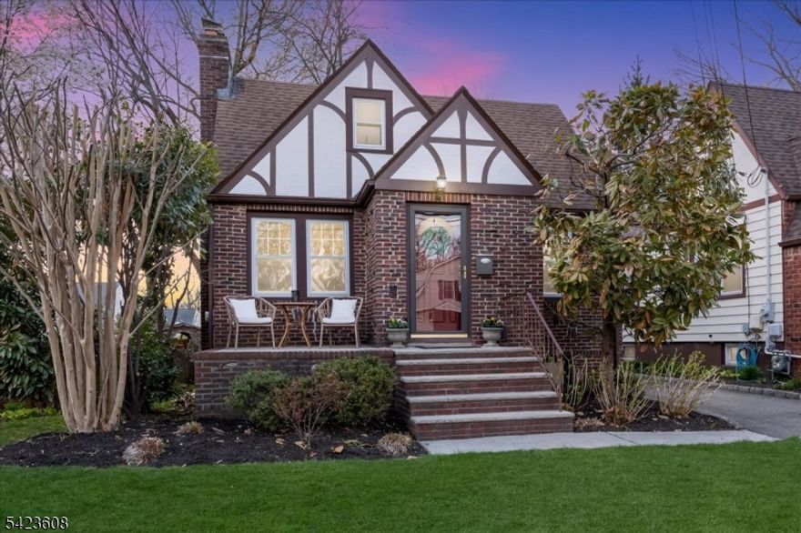 Welcome to this light-filled Tudor-style home offering timeless character and a spacious, flexible layout. A charming stone front patio provides the perfect spot to relax and enjoy the neighborhood. This lovely home features three bedrooms and one full bath plus two half baths and two convenient first-floor bedrooms. The second floor has an expansive bedroom and powder room with ample closets for additional storage.The inviting living room showcases oak hardwood floors and a decorative fireplace, flowing seamlessly into the dining room. The galley-style kitchen features granite countertops and stainless-steel appliances, providing both style and functionality. An entry vestibule with a coat closet adds a practical and welcoming touch The finished basement offers exceptional additional living space with a wet bar, wine refrigerator, and whimsical porthole windows, creating a fun and unique atmosphere for entertaining. A laundry area and spacious powder room complete this level. Step outside to a private backyard with a paver patio and a detached one-car garage, ideal for outdoor gatherings or quiet evenings.Perfectly located near dedicated bike and walking paths and close to Orange Avenue School. Roosevelt Park is just two blocks away. Enjoy everything Cranford is known for, including its award-winning downtown filled with restaurants, boutiques, yoga studios, gyms, and a movie theater, along with NYC train and bus service and easy access to major highways.