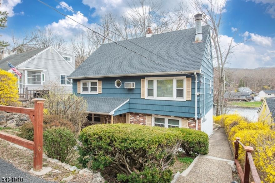 Imagine waking up each morning to the gentle sound of water lapping against the shore, right at your doorstep. This charming raised Cape Cod home on Skyline Lake offers a serene retreat that perfectly complements the vibrant beauty of its natural surroundings. As you step inside, a sense of warmth and comfort envelops you, inviting you to explore further. The home is more spacious than it appears, providing a versatile layout that accommodates both cozy gatherings and larger celebrations with ease. Featuring two kitchens, it offers the perfect setup for hosting everyone or creating a self-contained guest suite. The well-maintained interior invites you to add your personal touch, ready to evolve with your unique vision. Outdoors, your private dock awaits, promising afternoons filled with fishing, kayaking, or simply soaking in the tranquil lakeside views. It's not just a home; it's a lifestyle that invites you to savor every moment. Opportunities like this are rare - reach out today to make this lakeside dream your reality. New roof 2026.