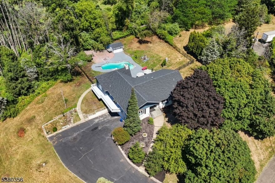 Rarely does a home of this caliber become available. Tucked away on a private road atop one of Clinton Township?s highest elevations, 1 Rossi Dr offers a rare blend of privacy, scenic beauty, and modern comfort. This recently renovated custom raised ranch features nearly 4,000 sq ft of finished living space with 4 bedrooms and 3.5 baths and an open-concept layout designed for both everyday living and entertaining. Bamboo flooring, expansive windows, and a dramatic waterfall quartz island kitchen anchor the main level, flowing seamlessly into the sunken living room and great room.The walk-out lower level provides exceptional versatility with a recreation room, kitchenette/wet bar, fitness space, full bath, and private entrance, offering flexible options for a private suite, guest accommodations, or multi-purpose living space.Outside, enjoy a private retreat with a gunite in-ground pool, firepit, deck, and mature landscaping. Located just minutes from Clinton Township?s historic downtown, dining, shopping, and major commuter routes, while surrounded by peaceful countryside views. An adjacent 5-acre parcel is also available, creating a combined 11-acre opportunity. Buyer to independently verify zoning and development potential.