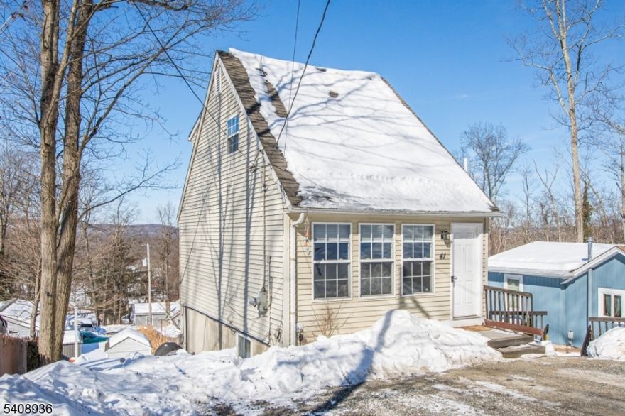 This charming custom home in the Cozy Lake section of Jefferson Township offers the perfect blend of warmth, functionality, and flexible living space within a private lake community, featuring lake and mountain views.  Located on a quiet dead-end street, the home is just minutes from Berkshire Valley Golf Course and Mahlon Dickerson Reservation's miles of hiking and biking trails. Ideal for a first-time homebuyer, downsizer, or weekend getaway, this home delivers comfort and versatility in a highly desirable setting. The sun-drenched main level welcomes you with a comfortable living room and a delightful eat-in kitchen featuring abundant pantry storage perfect for everyday living and entertaining. Upstairs, the primary bedroom retreat includes a spacious walk-in closet and a full bath. The finished walk-out lower level adds incredible flexibility, offering a cozy family room, a potential guest room, office, or playroom, an additional full bath, and a convenient laundry area. Optional Cozy Lake membership provides access to swimming, fishing, and boating. Enjoy the best of both worlds with a convenient commuter location close to major highways, nearby golf, scenic outdoor recreation, and the relaxed charm of lake community living. Don't miss this one!