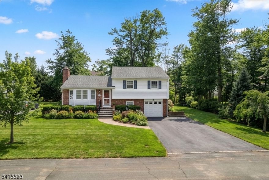 Located in a sought-after neighborhood, this beautifully maintained home has impressive curb appeal with manicured shrubbery and a welcoming paver walkway leading to the entry. Inside, light-filled spaces, hardwood floors, plantation blinds, and a thoughtfully designed layout create the perfect flow for both everyday living and entertaining. The spacious living room features a cozy fireplace flanked by built-ins, a sunny bay window, and a convenient coat closet, and opens seamlessly to a spacious dining room. The light and bright kitchen boasts stainless steel appliances, a wealth of cabinetry, granite countertops, and a roomy peninsula. The flow continues into the breakfast area and family room. This inviting space is enhanced by tall ceilings, while a gas stove adds warmth and character. Sliders lead to a charming three-season porch featuring a slate floor and access to the paver patio and level backyard beyond. Upstairs, you'll find three comfortable bedrooms, a full bath, and linen closet. The ground floor offers a versatile recreation room, powder room, and laundry room. Direct access to the patio and garage are also found here. A lower level provides abundant storage and exciting potential for additional living space. Complete with a fantastic location, this lovely home is complemented by tree-lined streets leading to downtown shops, dining, Midtown Direct trains, and top-rated schools.