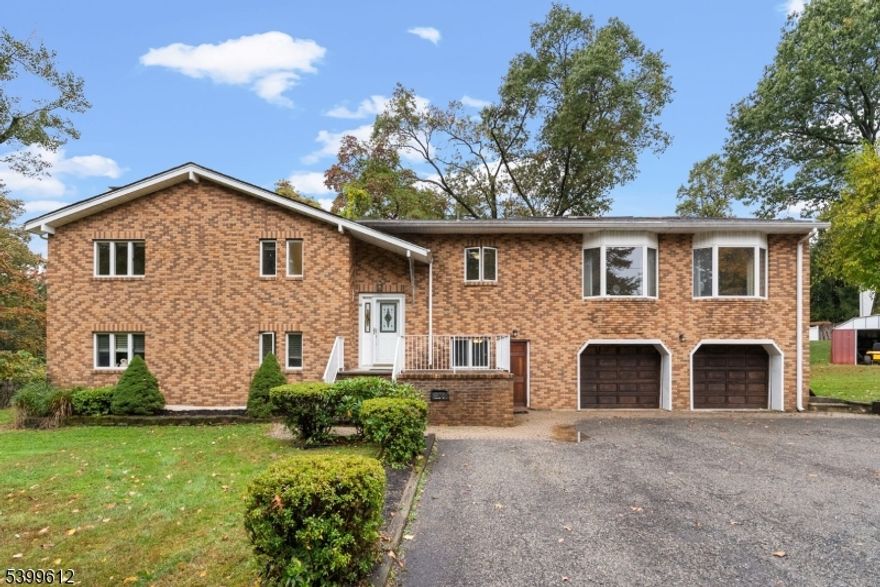 This impressive three bedroom + two office custom brick home offers exceptional space and versatility, featuring living areas and a full kitchen on each level ideal for guests or extended living. The main level showcases high ceilings, abundant closet space throughout, and access to a large deck overlooking the property's private surroundings. The expansive primary suite includes two walk-in closets and a private bath, and bathrooms throughout the home have been beautifully redone. A wood-burning stove on the first level, a rare four-car garage, and easy highway access for commuting complete this inviting property offering comfort, convenience, and timeless character. Home has a three-bedroom septic.