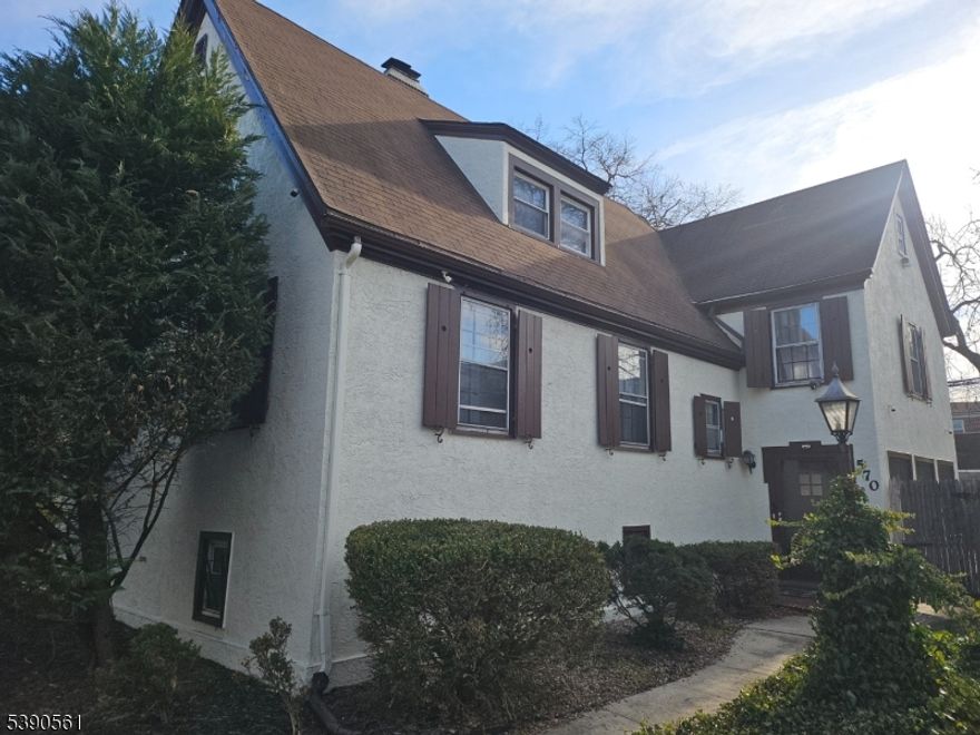 English Rose Tudor brimming with Style, Architectural Details, and Possibilities. The home is a blend of old-world charm, complete with original hardwood floors with ribbon inlays, crown molding, French doors, a cedar closet, and a cozy wood burning fireplace to set the mood. The home features 3 oversized bedrooms, including a master suite with new laminate flooring and lighting. The 1/2 bath off the master bedroom awaits your imagination to expand to a full-on suite bath. The main bath has been completely renovated and reflects today's needs. The kitchen is a blend of both worlds with new quartz countertops and a new tiled floor, coupled with refinished original wood cabinets. Window shutters in the kitchen emphasize the original charm. The home has been recently painted on the exterior and has had some Anderson Windows installed in the family room. Enjoy the backyard patio /sitting area and private shed for additional storage. Basement is finished with an half bath and easily could serve as an office, gym or play area. Owner has paperwork that oil tank was removed. Seller offering 10k credit back at closing for closing costs or "Enhancement Fee"