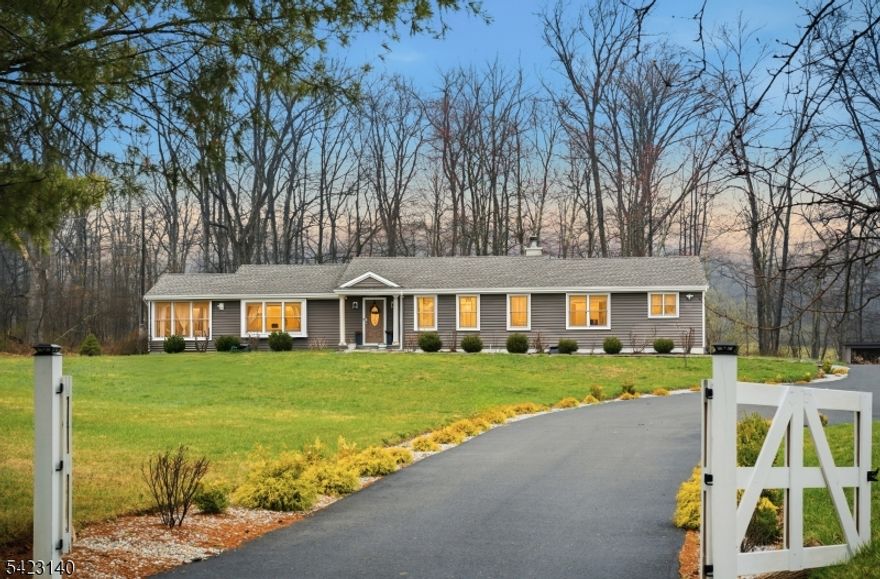 Welcome to a home that was never meant to be sold. Every upgrade was made with long-term living in mind, creating a rare opportunity to own a space built with true care and intention. This fully renovated modern home blends luxury and comfort across 3,900 sq ft, featuring 4 bedrooms, 3 baths, a fully finished basement and set on 3.12 private wooded acres. Inside, you'll find a bright, airy layout with Andersen windows and laminate flooring throughout. The kitchen is a standout with a herringbone backsplash, stainless steel appliances, coffee bar, extensive cabinetry, center island, and quartz countertops. Spacious bedrooms offer abundant closet space, while a private laundry with wet room adds convenience. A convection wood-burning fireplace brings warmth and charm. Outside, enjoy a backyard oasis with cement pavers leading to a 20x40 deck, surrounded by mature trees for ultimate privacy. Preserved land next door ensures your peaceful setting remains untouched. A new 3-car garage and large driveway provide plenty of parking. Upgrades include new plumbing, electric, newer septic, roof (2021), spray foam insulation, CAT-5 wiring, and energy-efficient mini splits. This home truly stands out in the highly sought-after town of Tewksbury. Minutes away from major highways like Routes 206, 22, and 78.