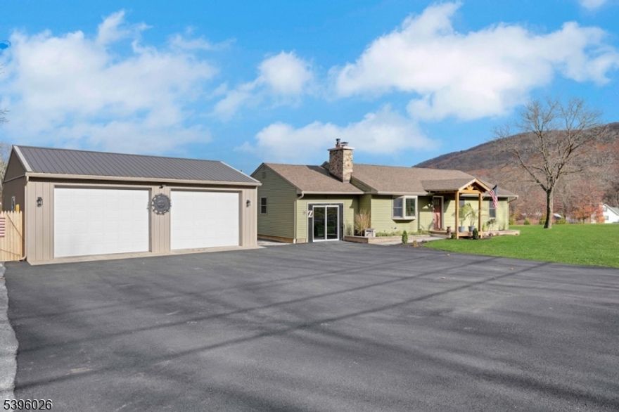 Imagine coming home to your very own "mini resort" nestled between New Jersey's premier ski and golf resorts(location convenient to drive your golfcart to the club to play), with the Appalachian Trail just moments away! This updated ranch with year round panoramic mountain views boasts recent updates that includes newer septic (2024) new doors, new fencing surrounding a brand new heated swimming pool (summer '25) with stone paver/stone surround, newly landscaped to include an 80 yard putting/drive practice green to sharpen your skills! A brand new oversized driveway (Oct. '25) surrounds the detached poll barn which is just perfect for entertaining and/or that additional workshop you may need! Inside, cozy up to a fire burning in the fireplace in cooler weather! Flex room is third bedroom. New gutters and new stone veneer add a rustic warmth to this lifestyle home! This is not to be missed!