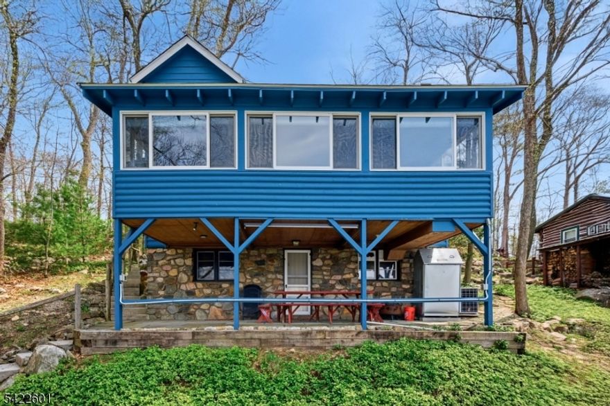 Enjoy exceptional main-lake lakefront living with deep water and gorgeous sunsets from your private dock and inviting enclosed sunroom. Perched high on the lot for sweeping lake views, this special setting offers a true front-row seat to lake life. Ideally located across from the main beach and clubhouse, where you can enjoy swimming, gatherings, and a variety of seasonal activities bringing the energy and charm of the lake right to your doorstep.Welcome Home