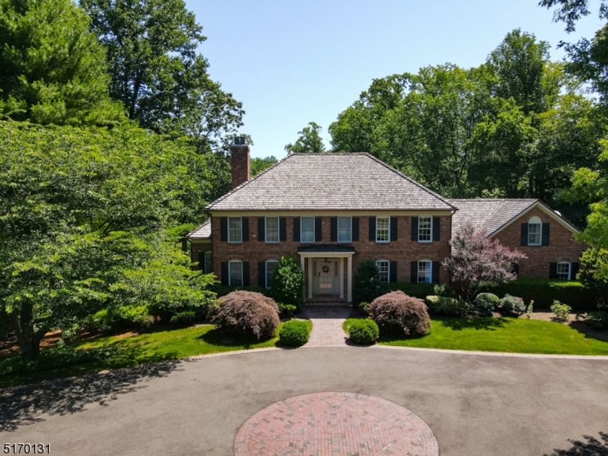 Welcome to this 5 bedroom, 3 full, and 1 powder room elegant brick colonial situated on one of the most sought-after streets in Bernardsville. No expense was spared in this home crafted with attention to detail using only the highest quality finishes. The home sits on 5 acres of serene and beautifully landscaped grounds with rolling lawns, mature trees, a resort-like pool and spa, a spring-fed pond, and a small beach area. The home also features a deer fence, a vegetable & flower garden, a chicken coop, a fire pit, two sheds, a three-sided shed for equipment storage, a detached two-port garage with loft storage, and an attached three-car garage. Enter through the foyer to find a formal dining room, formal living room with built-in surround sound, office, sunroom, family room, and a custom chef's kitchen with a Viking Refrigerator and Gas Range. The second floor features 4 bedrooms, including a private primary suite with a stunning walk-in closet, ensuite full bath, and a sitting room. This magnificent home is also perfect for entertaining with a full, finished lower level that flows seamlessly to the outdoor living spaces. A new heavy hand-split cedar shake roof was recently replaced (2020), and newly installed copper gutters (2020). This home is truly a must-see!