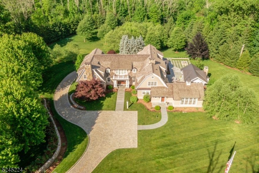 This modern and beautifully detailed home offers a fresh take on classic architecture, featuring on-trend design details and exquisite craftsmanship. Built-in 2008 updates in 2023 and 2024, this Shingle-style estate exudes understated elegance and sophistication like coastal estates in the Hamptons and Newport. Privately set on 3.42 acres with a gated entry and professionally landscaped grounds, the exceptional property is accented with gas lanterns, expansive bluestone terraces, meandering stone walls, Belgium block curbing and parking courts, and beautiful mature plantings. The 8,500+/- square-foot layout (including the finished  lower level) enjoys stunning Christopher Peacock kitchen and baths, dramatic great room with stone floor to ceiling fireplace, gorgeous billiard room, beautiful mahogany library w/cigar lounge and humidor, four/five bedrooms, five full baths, two powder rooms, and a four-car heated garage with a cold plunge tub. This home is perfect for formal entertaining or casual gatherings.  Bespoke details include layered crown moldings, wainscoting, quarter-sawn five-inch plank white oak floors, radiant heated flooring (primary bath, billiard room, garage, gym, detached office) high ceilings, lustrous mahogany paneling, 3 fireplaces, and freshly painted interiors and exterior. Expansive window walls frame the pastoral outdoor setting and fill the home with an abundance of natural light. No known issues with chimneys. sold "as is"