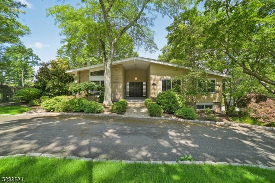 As you drive through the circular driveway you will be impressed by the attractive curb appeal.  Stunning & sunlit 5 bedroom, 3.5 bath contemporary Ranch is surrounded by the mature landscaped property.  As you are greeted into the exquisite entrance with high ceilings, the open floor plan is wonderful to entertain. The large family room features a floor to ceiling stone wood-burning fireplace,  spacious living room, perfect for social gatherings.  You will love the designer eat - in kitchen that offers exceptional quality wood cabinets,  expansive center island, granite counter top,  high end appliances and  French doors that leads to the patio. The dining room is situated off of the kitchen with a French door that leads to the oversized deck with easy access to the backyard. Three bedrooms are nestled on the first floor with the primary bedroom en-suite that  provides two walk-in closets,  built-ins, bathroom with a soaking tub and a separate stall shower.  In addition, two bedrooms share the new main bathroom with two sinks and bespoke shower.  The walkout lower level provides  two bedrooms,  new full bathroom,  thermostatically controlled wine room, freshly painted recreation room and new laminate wood floor.   Close-by to the Top Rated Millburn Schools, Mid-Town Direct Train into NYC, Millburn downtown shops & restaurants make this a wonderful place to live.