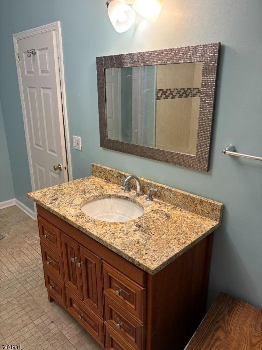 Welcome to this beautifully maintained 2nd-floor apartment in a private 3-family home. This spacious unit features 2 Bedrooms and 2 full Bathrooms, offering a rare layout designed for privacy and comfort. The heart of the home is an updated eat-in kitchen boasting granite countertops, stainless steel appliances, and a convenient breakfast nook. Enjoy high ceilings, hardwood floors, and plenty of natural light throughout. Bonus features include built-in bookshelves, ceiling fans, and a large shared yard. Parking for 1 car is included! Perfectly located for commuters: just a short walk to the Park Ave bus and minutes from the East Orange train station with direct access to NYC. No pets. Move-in ready!